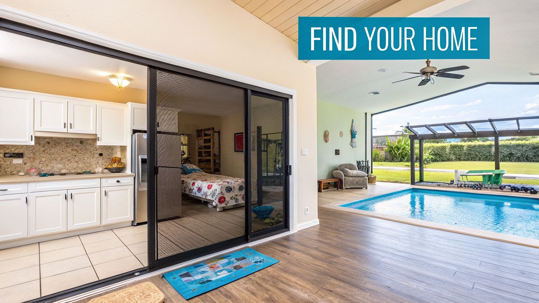 Inside a home looking out to a bright blue swimming pool and a green landscaped backyard.